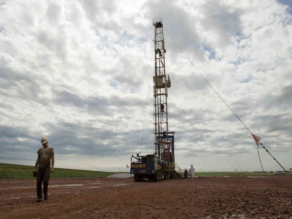 Austin Mitchell walks away from an oil derrick outside Williston, N.D., in July 2011. North Dakota is now the No. 2 producer of oil in the U.S. behind Texas.