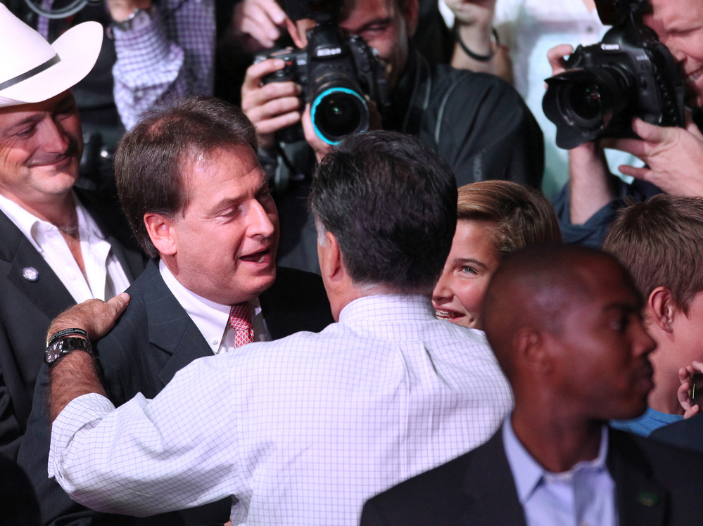 Republican presidential nominee Mitt Romney greets Nevada Lt. Gov. Brian Krolicki, center, following a rally in Reno, Nev., Wednesday.