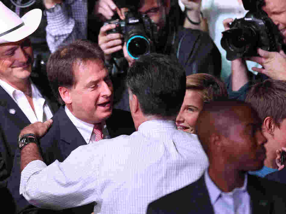 Republican presidential nominee Mitt Romney greets Nevada Lt. Gov. Brian Krolicki, center, following a rally in Reno, Nev., Wednesday.