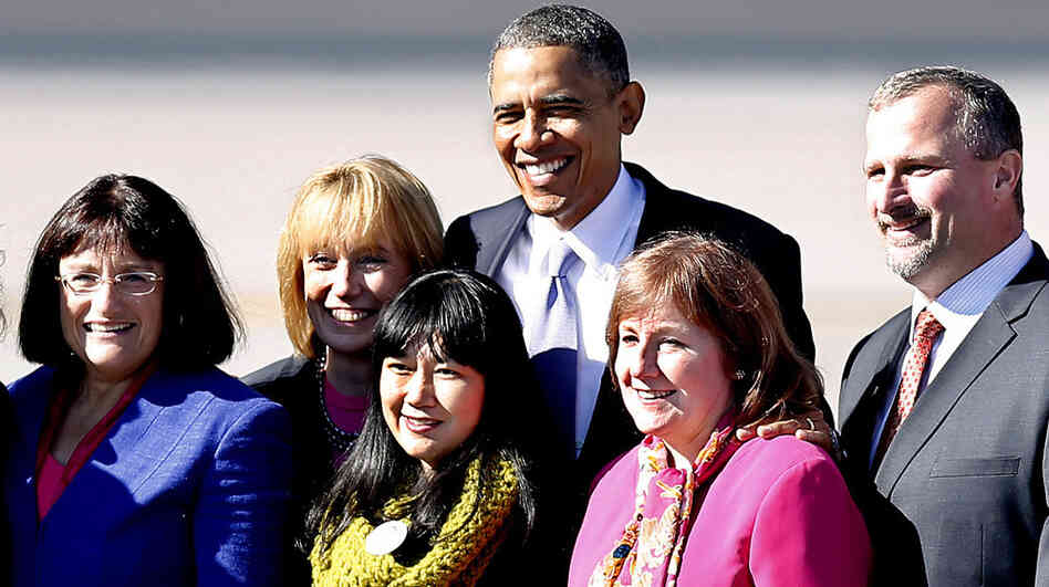 President Obama pauses for a photo with supporters after arriving for a campaign stop in Manchester, N.H., on Thursday.