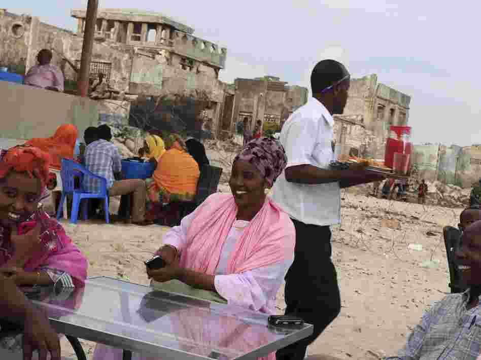 Somalis chat at a beach-side restaurant earlier this month. After two decades of civil war, Somali's capital, Mogadishu, is beginning to recover. Somalis chat at a beach-side restaurant earlier this month. After two decades of civil war, Somali's capital, Mogadishu, is beginning to recover.