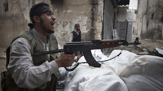 In Aleppo, Syria, an opposition fighter shouted as he manned a position on Monday.