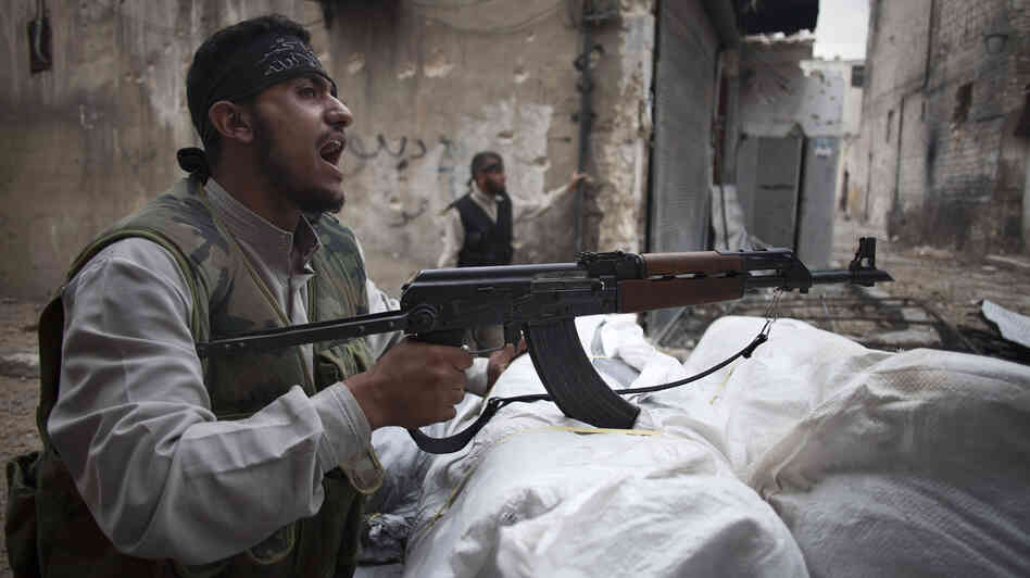 In Aleppo, Syria, an opposition fighter shouted as he manned a position on Monday.
