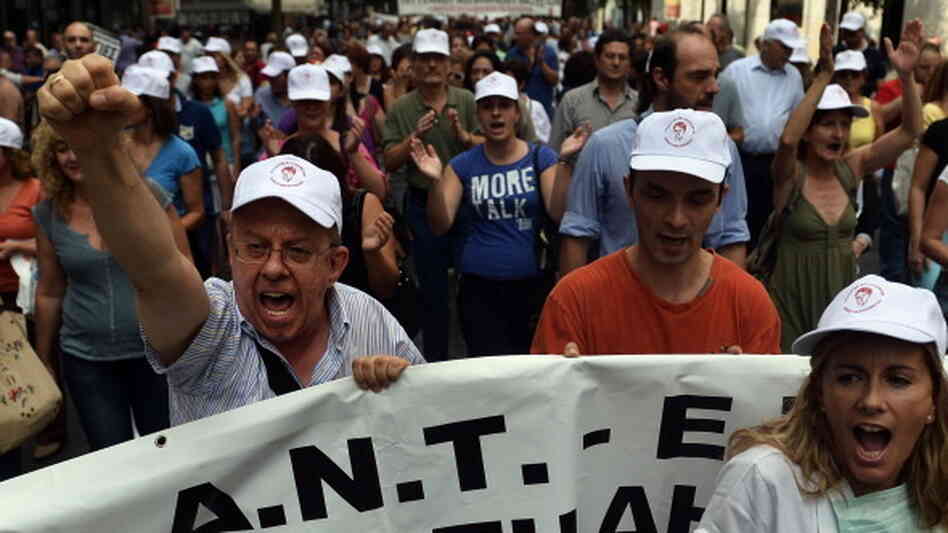 Health employees protest outside the Health Ministry in Athens against pay and budget cuts. Fewer resources for malaria treatment and mosquito control may be contributing to malaria's comeback in Greece.