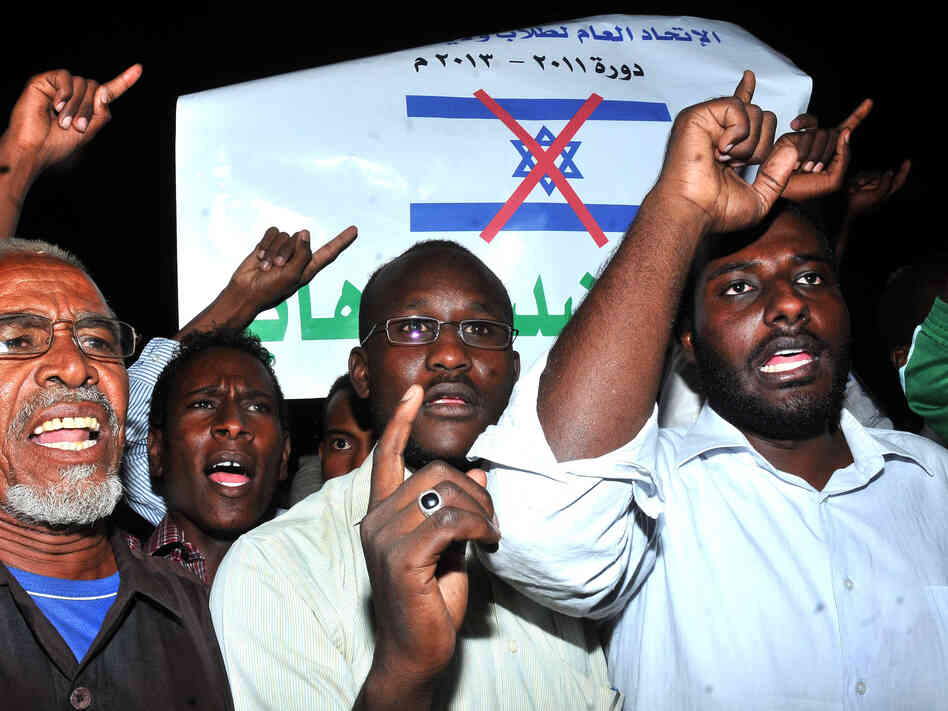 Sudanese demonstrators hold banners and chant anti-Israeli slogans during a protest in Khartoum on Wednesday, following a missile strike that hit a factory. Sudan blames Israel for the attack. Israel has not commented on the charge.
