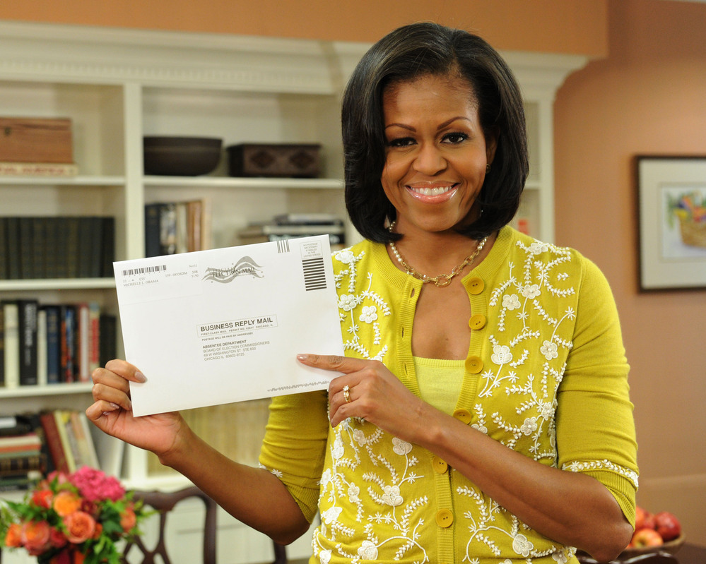 First Lady Michelle Obama prepares her absentee ballot for the upcoming elections.
