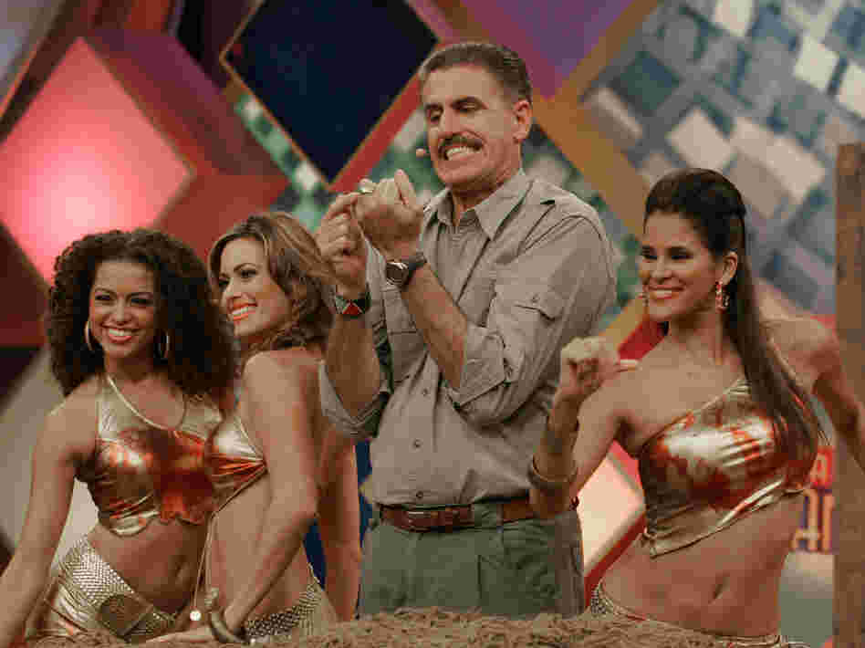 Zoologist Ron Magill points to his wedding ring as dancers surround him during a 2006 taping of Sábado Gigante.
