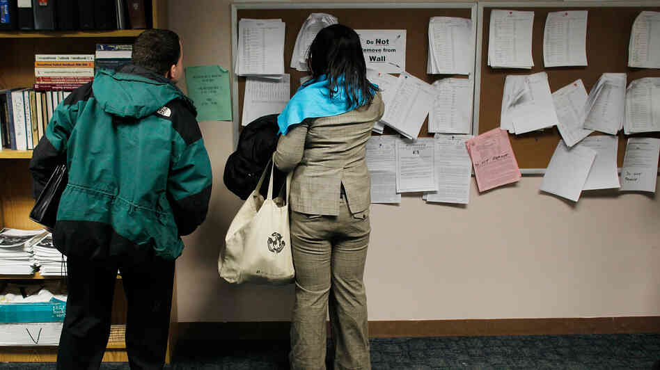 Two people check job listings at a New York State Department of Labor Employment Services office in Brooklyn. (March 2011 file photo.)