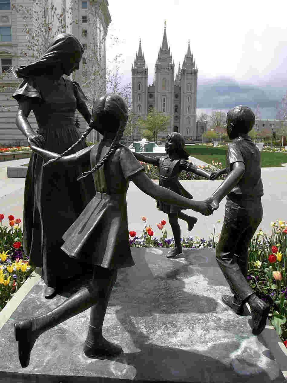 A statue representing womanhood — and women's role in raising children — is seen with the Mormon Temple in the background in Salt Lake City.