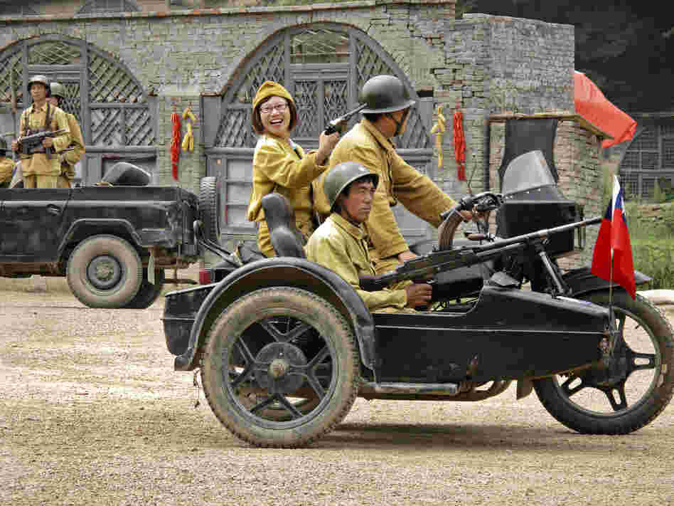 Other tourists wear the mustard-colored uniforms of the Nationalists led by Chiang Kai-shek, the Chinese Communists' opponents in the country's civil war.