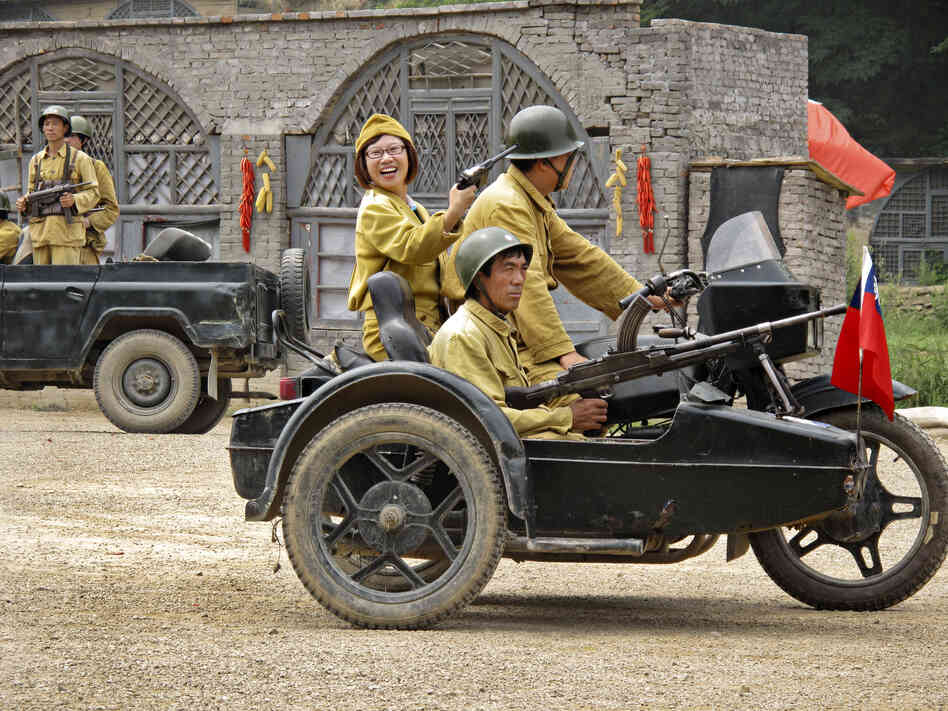 Other tourists wear the mustard-colored uniforms of the Nationalists led by Chiang Kai-shek, the Chinese Communists' opponents in the country's civil war.