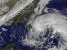 In this satellite image provided Friday by the National Oceanic and Atmospheric Administration, Hurricane Sandy's huge cloud extent of up to 2,000 miles churns over the Bahamas, as a line of clouds associated with a powerful cold front approaches the East Coast of the U.S.