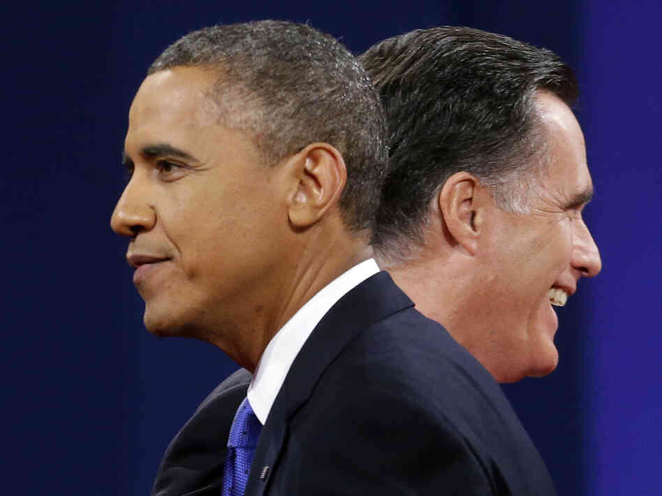Mitt Romney and President Obama walk past each other after debating Monday in Boca Raton, Fla.