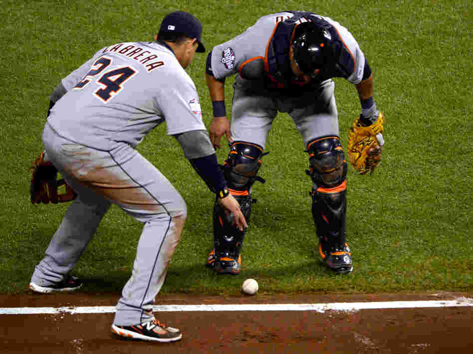 Please go foul, please go foul, please go foul: Third-baseman Miguel Cabrera (No. 24) and catcher Gerald Laird of the Detroit Tigers watched closely to see if a bunt by the Giants' Gregor Blanco would go foul Thursday night in San Francisco. It didn't. The Giants scored and went on to win the game and take a 2-0 lead in the World Series.