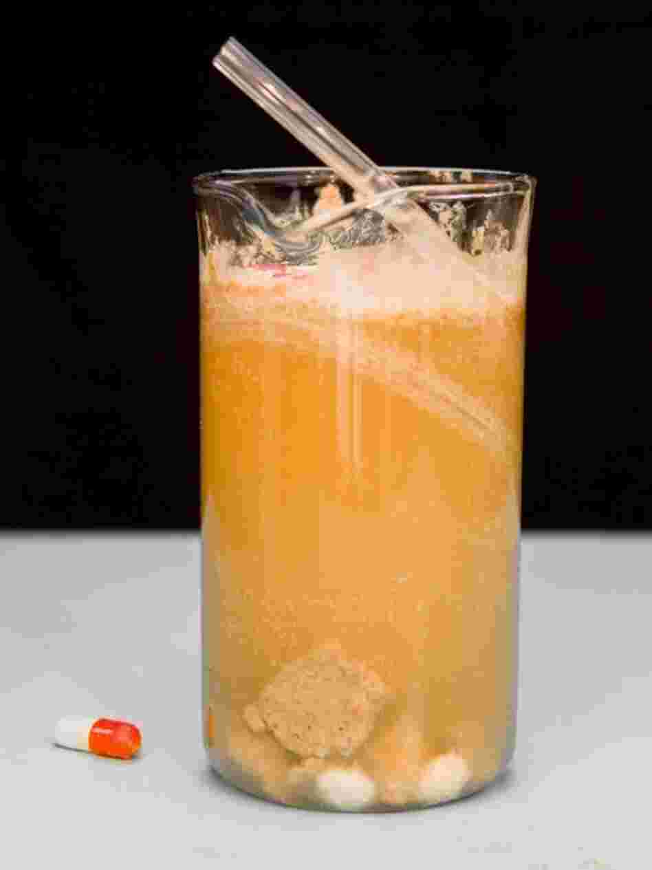 Suicide Stomach Contents: Bartender James Dance of Loading in Cornwall concocted this mixture of flavored vodka, chocolate pieces, skittles, and absinthe, with empty pill casings for garnish, modeled on pathology lab stomach specimen.