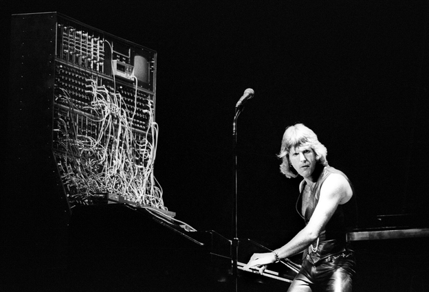 I think we can all agree that he deserves at least a little bit of the blame: Keith Emerson of Emerson, Lake & Palmer on stage with his Moog synthesizer.