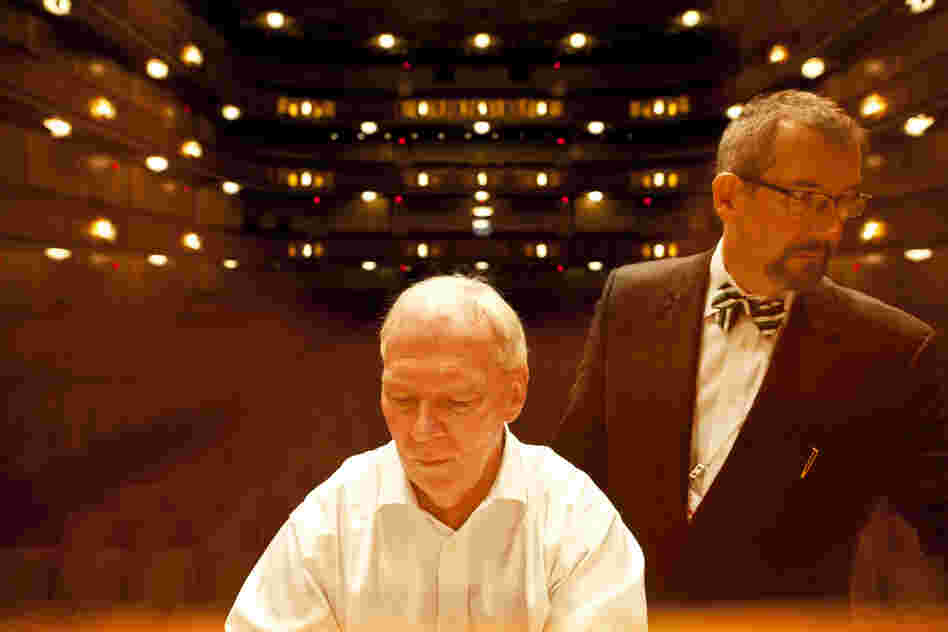 Neil plays the organ while organ consultant Jeff Weiler pushes and pulls stops during the test. Building the organ took nearly two years, plus more than three months for installation.