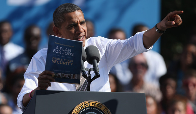 President Obama holds a copy of "The New Economic Patriotism: A Plan for Jobs & Middle-Class Security," which outlines some of his agenda for a second term, during a rally in Richmond, Va., on Thursday.