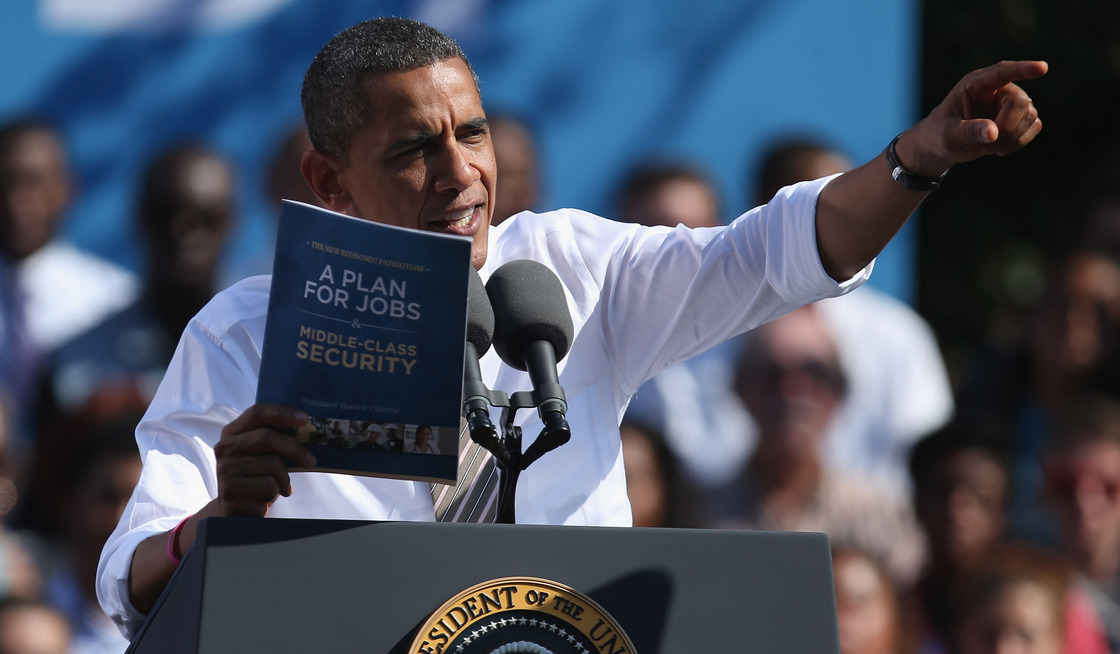 President Obama holds a copy of "The New Economic Patriotism: A Plan for Jobs & Middle-Class Security," which outlines some of his agenda for a second term, during a rally in Richmond, Va., on Thursday.