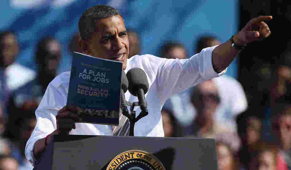 President Obama holds a copy of "The New Economic Patriotism: A Plan for Jobs & Middle-Class Security," which outlines some of his agenda for a second term, during a rally in Richmond, Va., on Thursday.