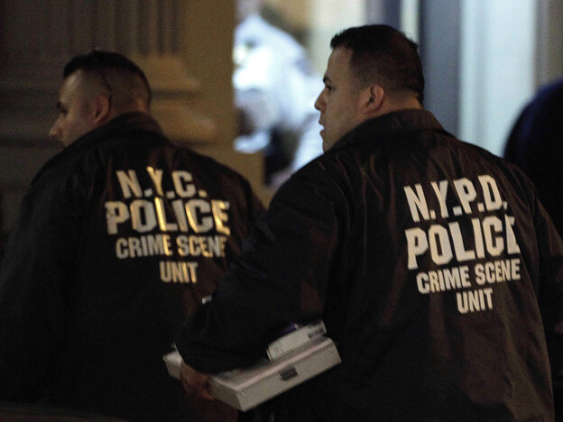Crime scene unit officers outside the Manhattan apartment building where the children were killed Thursday.