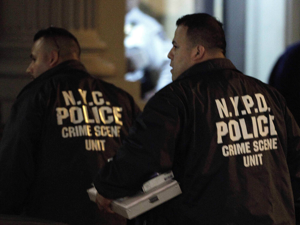 Crime scene unit officers outside the Manhattan apartment building where the children were killed Thursday.