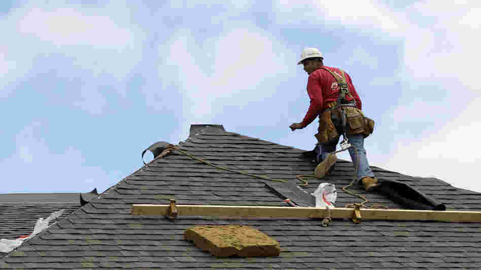 A construction worker finishes a roof in Chicago on Oct. 12. Signs of recovery in the housing market are springing up nationwide, but there's still a ways to go.