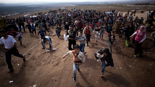 Children run after a truck loaded with presents for Eid Al-Adha in a refugee camp near Atma, Idlib province, Syria. A powerful car bomb exploded in Damascus on Friday and scattered fighting broke out in several areas across Syria, quickly dashing any hopes that a holiday cease-fire would hold.