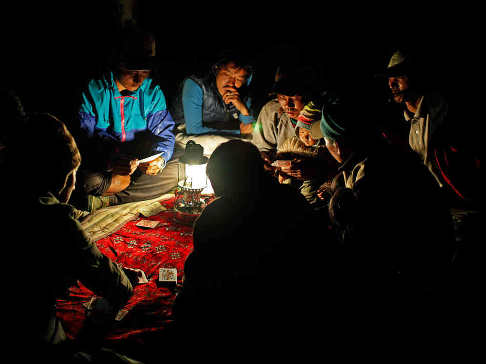 In the afternoon everyone goes back to the campsite. The men drink and play cards for most of the day until late into the night.