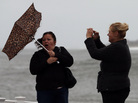 Hurricane Sandy's winds are already picking up in Cape May, N.J. Kim Vo (right) captures a Kodak moment of her friend, Lisa Cellucci. Hurricane Sandy's winds are already picking up in Cape May, N.J. Kim Vo (right) captures a Kodak moment of her friend, Lisa Cellucci.