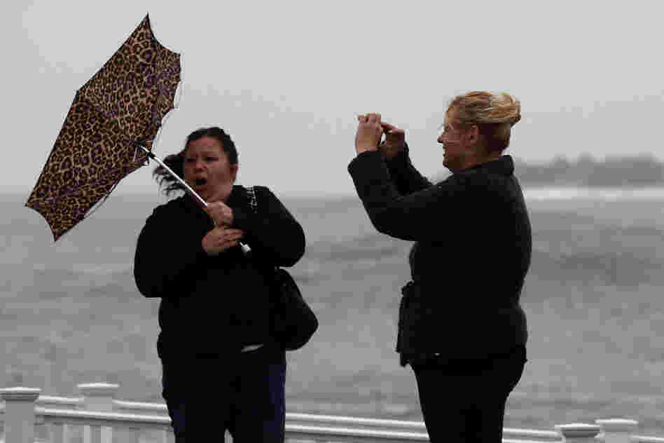 Hurricane Sandy's winds are already picking up in Cape May, N.J. Kim Vo (right) captures a Kodak moment of her friend, Lisa Cellucci.