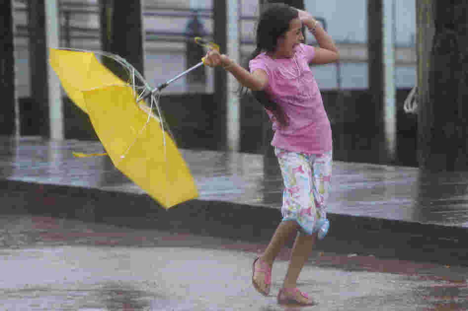 Kayla Mejia of Annapolis, Md., struggles again winds from Hurricane Irene, 2011.