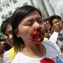 A bloodied woman is helped by demonstrators after clashes with police in a protest against an industrial waste pipeline in Qidong, Jiangsu province, on July 28. The Chinese government devotes enormous resources to suppressing dissent, but opposition to government policies is increasingly common. A bloodied woman is helped by demonstrators after clashes with police in a protest against an industrial waste pipeline in Qidong, Jiangsu province, on July 28. The Chinese government devotes enormous resources to suppressing dissent, but opposition to government policies is increasingly common.