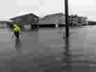 A Dare County utility worker checks on conditions along a flooded Ride Lane in Kitty Hawk, N.C., Monday, Oct. 29, 2012.