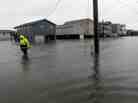 A Dare County utility worker checks on conditions along a flooded Ride Lane in Kitty Hawk, N.C., Monday, Oct. 29, 2012.