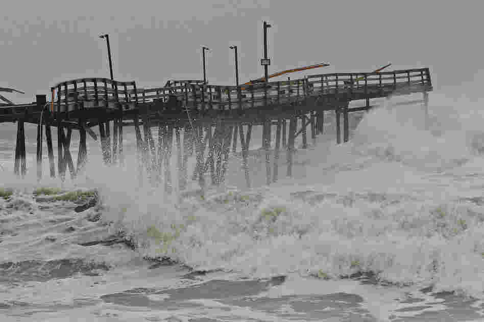 Waves crash onto the damaged Avalon Pier in Kill Devil Hills, N.C., as the hurricane churns up the East Coast. Sandy is sending coastal residents fleeing as it threatens a dangerous mix of high winds and soaking rain.