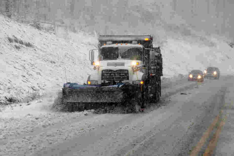 Snowplows move through Randolph County, W.Va. Sandy was set to collide with a wintry storm from the west and cold air streaming down from the Arctic.