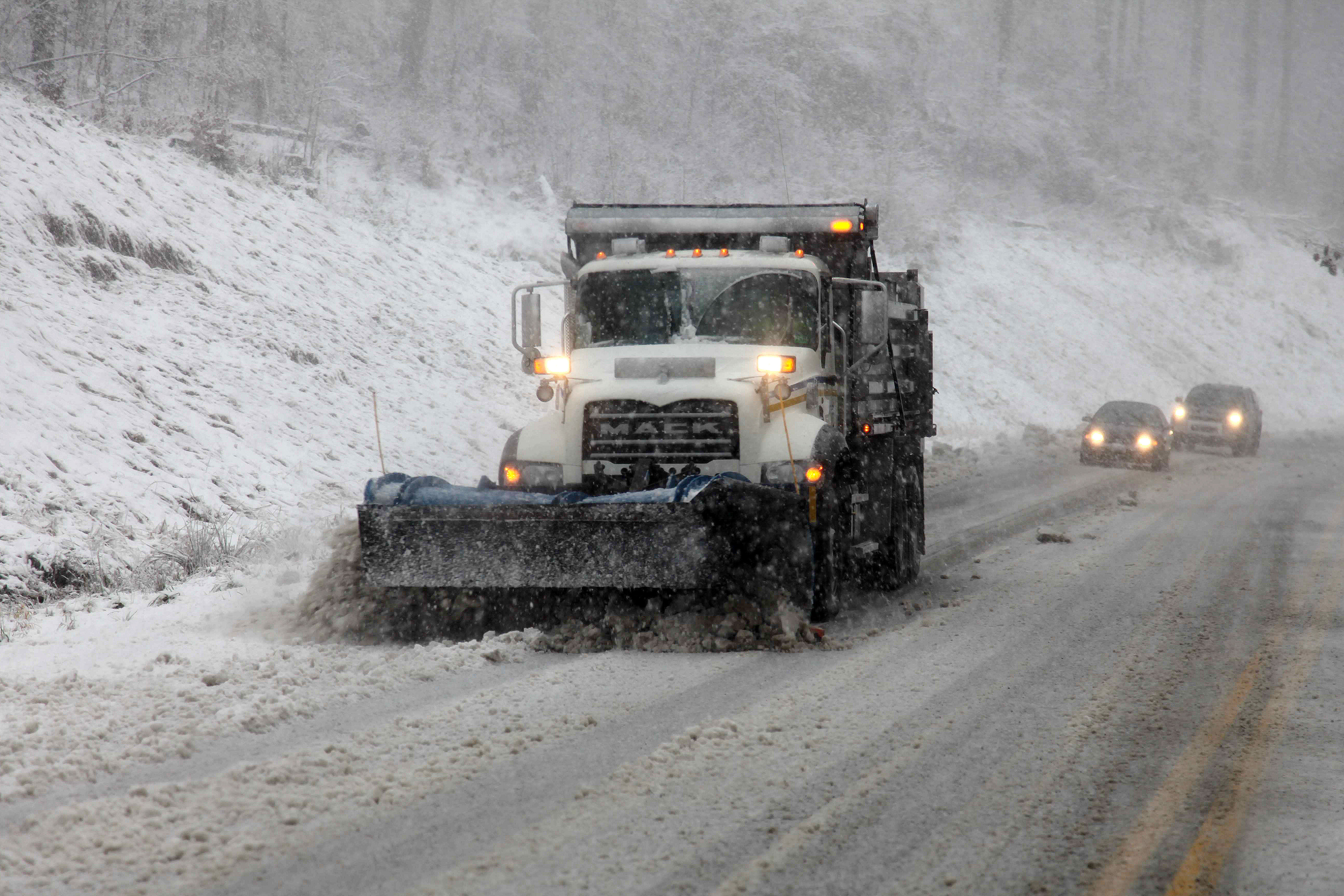 Snowplows move through Randolph County, W.Va. Sandy was set to collide with a wintry storm from the west and cold air streaming down from the Arctic.