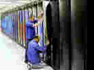 Cray employees put the finishing touches on Titan at the Department of Energy's Oak Ridge National Laboratory in Tennessee. The supercomputer may be the world's fastest. It's designed to do 20 petaflops — or 20,000 trillion calculations — each second. It consumes enough electricity to power a small city of 9,000 people.