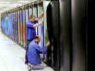 Cray employees put the finishing touches on Titan at the Department of Energy's Oak Ridge National Laboratory in Tennessee. The supercomputer may be the world's fastest. It's designed to do 20 petaflops — or 20,000 trillion calculations — each second. It consumes enough electricity to power a small city of 9,000 people.