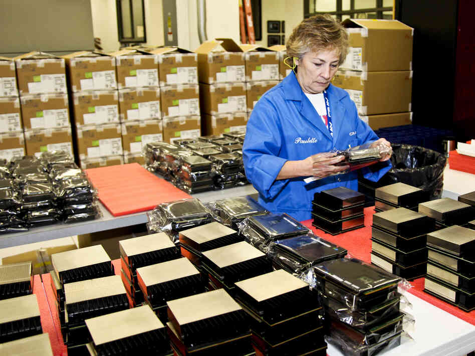 A Cray employee organizes the processors used to build Titan. To accelerate its processing power and conserve energy, Titan uses GPUs — graphics processing units. These chips were originally developed for the video game industry. A Cray employee organizes the processors used to build Titan. To accelerate its processing power and conserve energy, Titan uses GPUs — graphics processing units. These chips were originally developed for the video game industry.