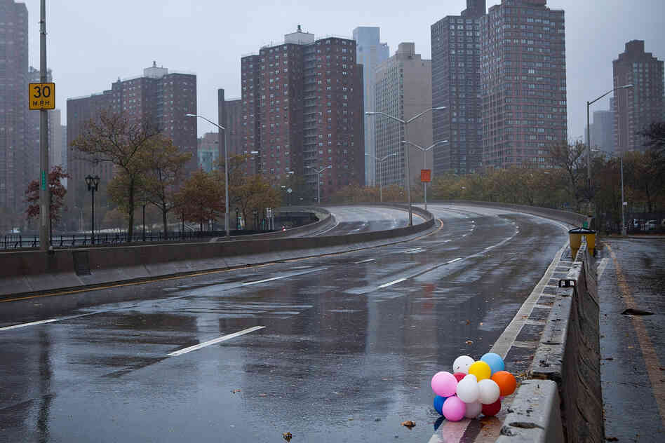 Balloons lie on the side of a closed New York City street Monday.