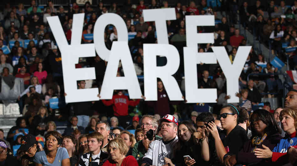 A crowd listens at a rally with former President Bill Clinton and Vice President Joe Biden in Youngstown, Ohio, on Monday. President Obama canceled his appearance to return to the White House to monitor Hurricane Sandy. Both campaigns have urged supporters whose states allow early voting to vote as soon as possible.