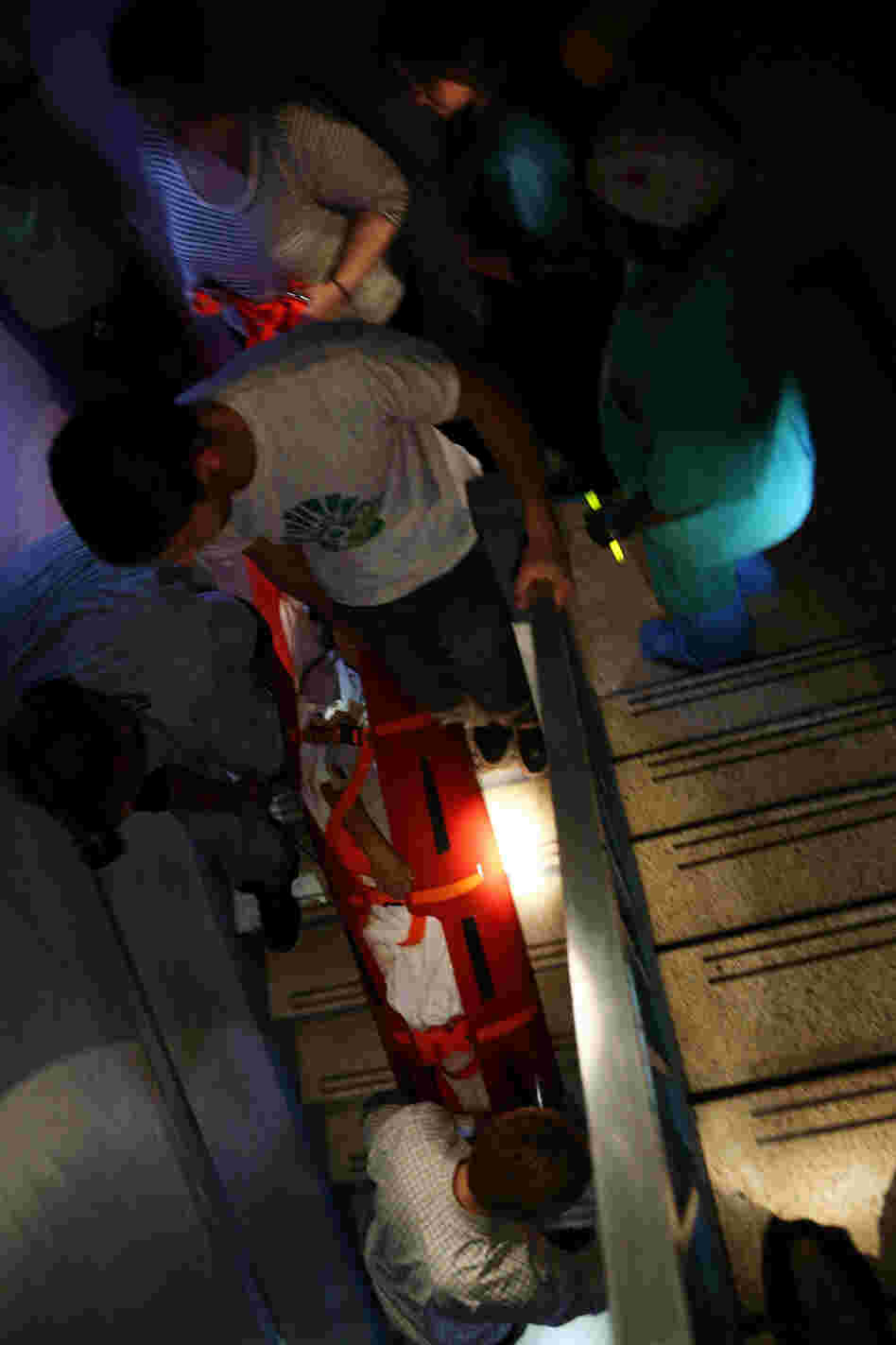 Hospital workers evacuate patient Deborah Dadlani from NYU Langone Medical Center in New York City on Monday.