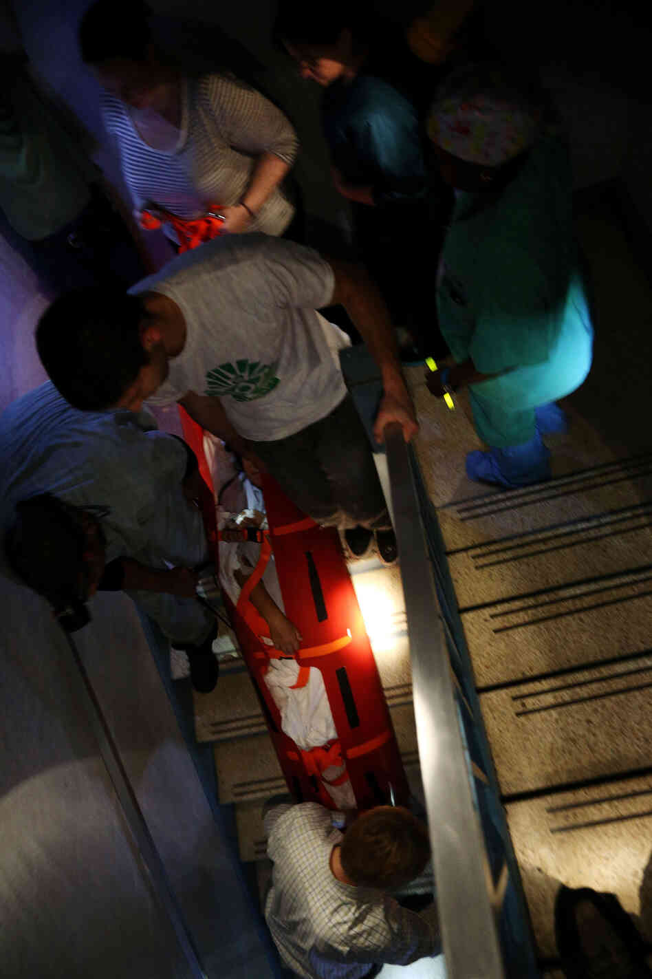 Hospital workers evacuate patient Deborah Dadlani from NYU Langone Medical Center in New York City on Monday.