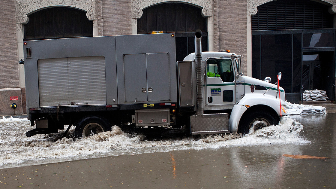 A truck drives through a flooded street caused by Hurricane Sandy in New York City's Financial District on Tuesday.