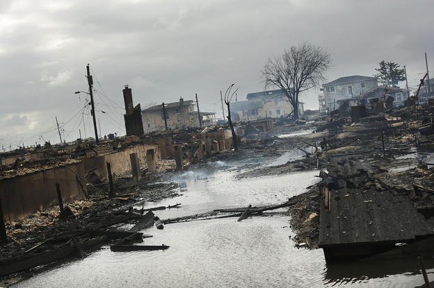Homes sit smoldering after Hurricane Sandy on Tuesday in the Breezy Point Neighborhood of the Queens.