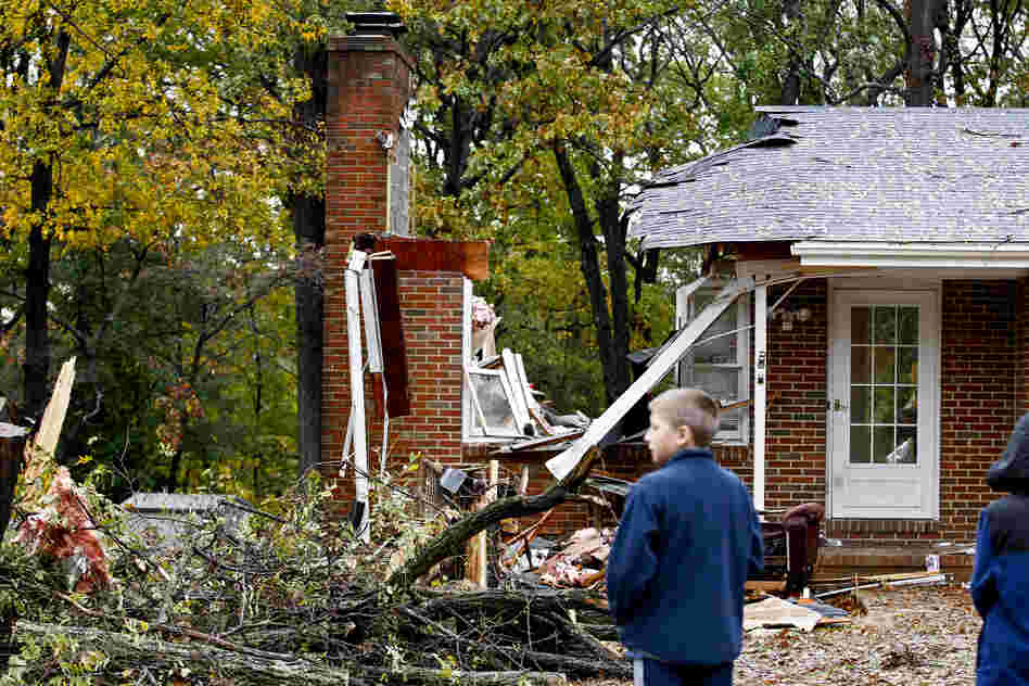 Reece Hiner, 11, looks at a destroyed home in Pasadena, Md., where the homeowner was killed overnight when a tree fell on his home during Sandy.