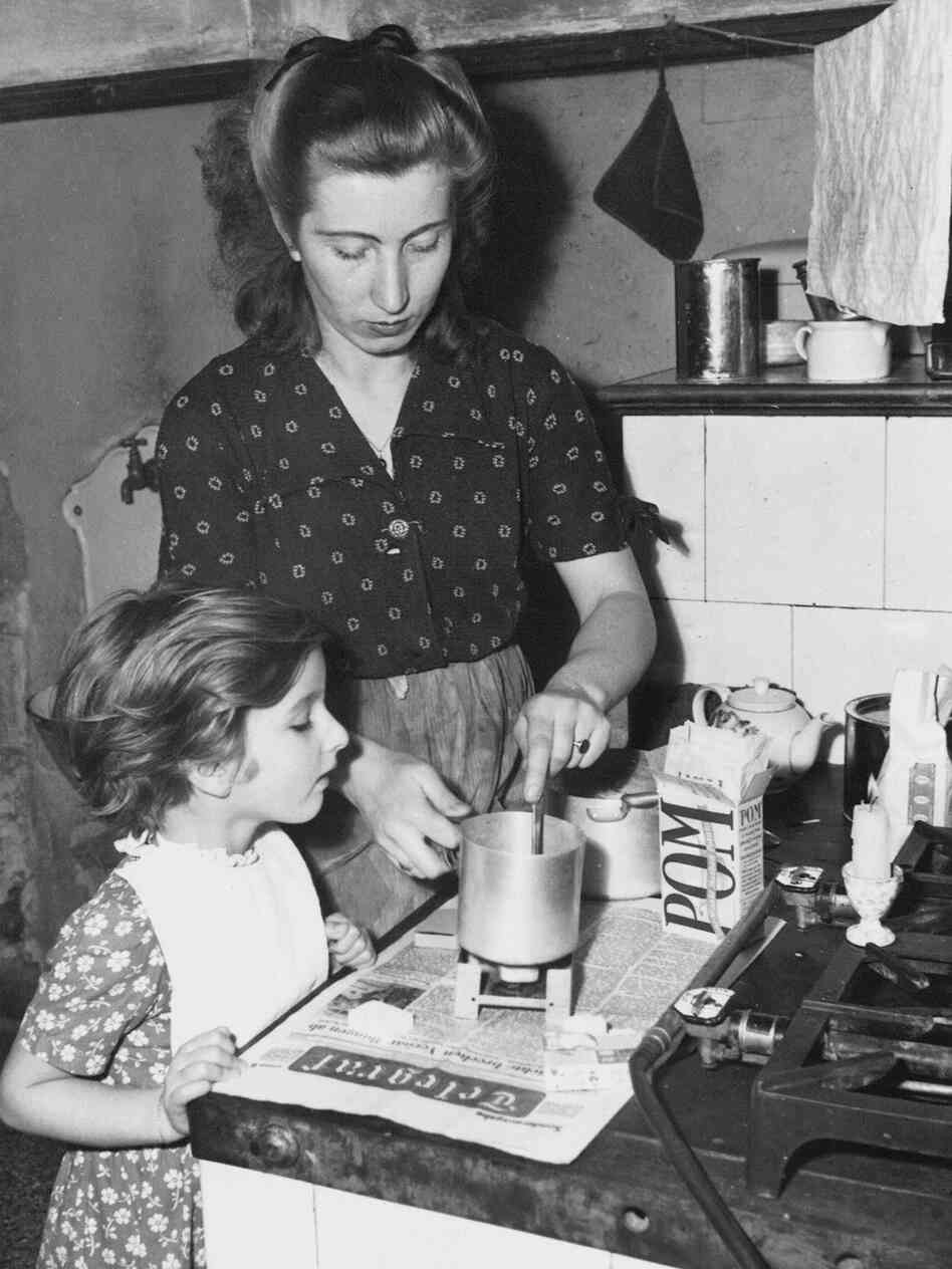 Sterno-type cooking in 1948. Many people still use these cooking tools today when disaster strikes.