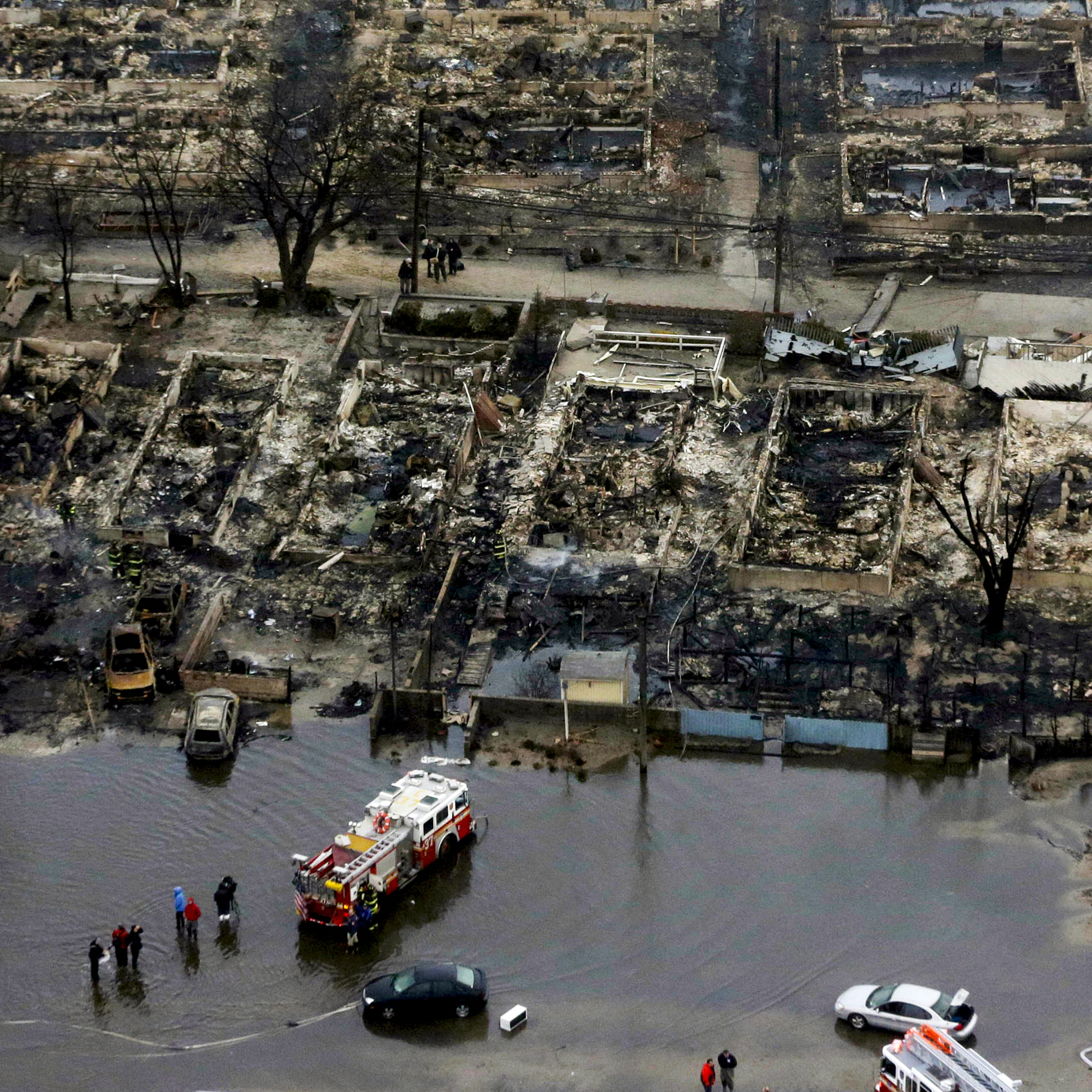 An aerial image of the burned-out homes of the Breezy Point, N.Y. After Sandy, fire and floodwaters transformed this quaint corner of the Rockaways into a smoke-filled debris field.